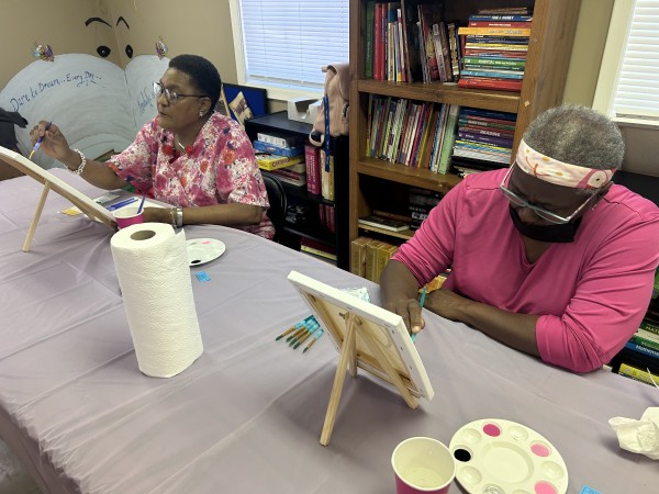 Residents painting on canvas